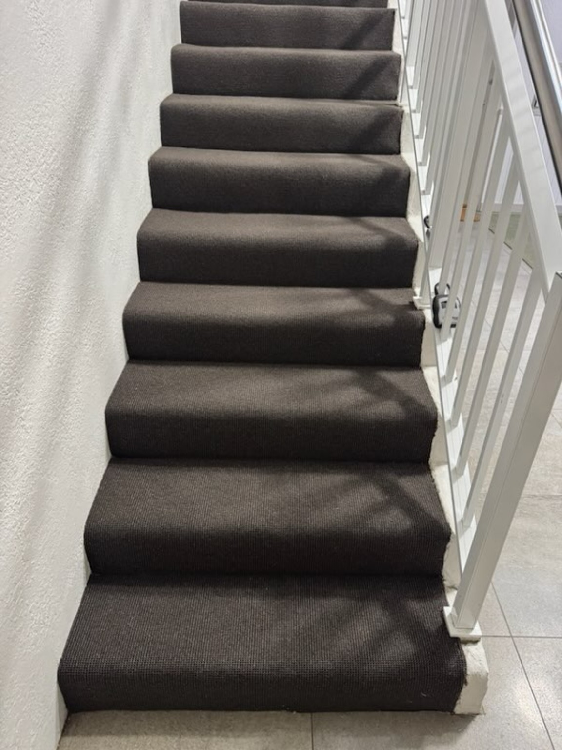 Completed multi-level staircase with charcoal carpet