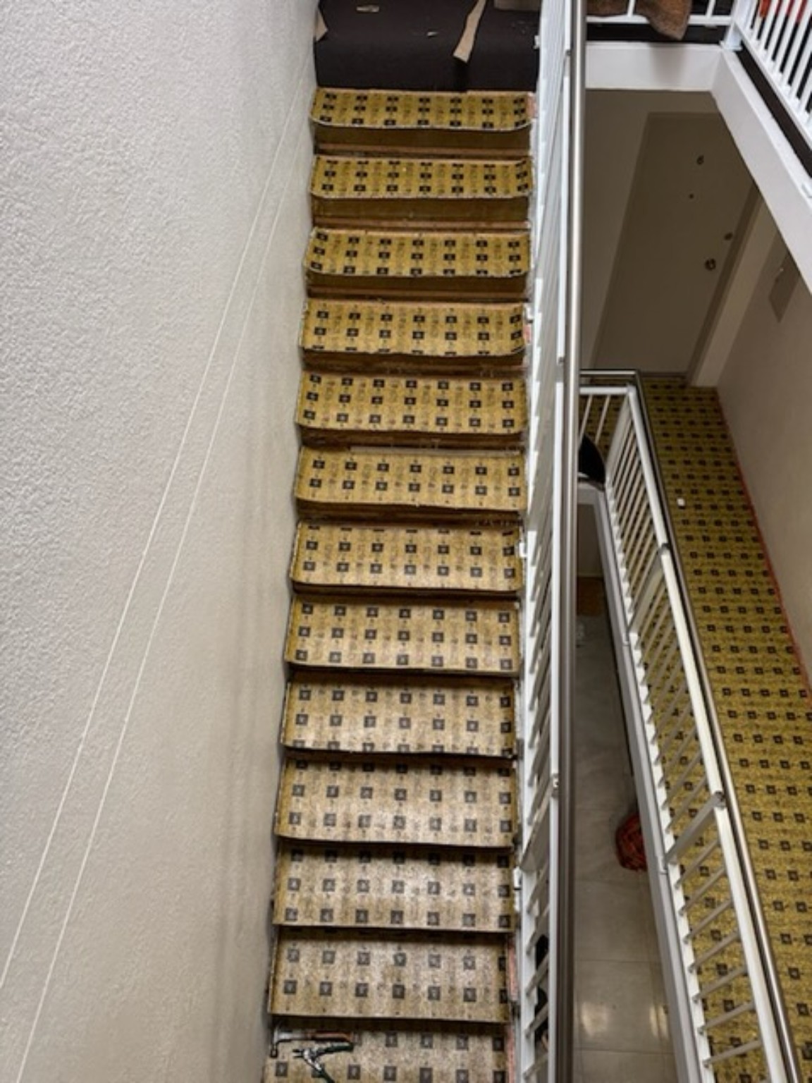 Old patterned carpet across a multi-level stairwell