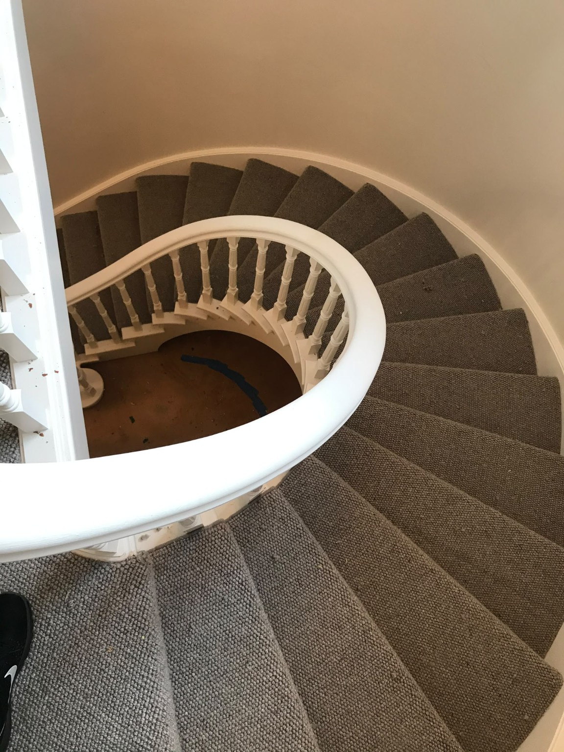 Carpet installed around a curved spiral staircase