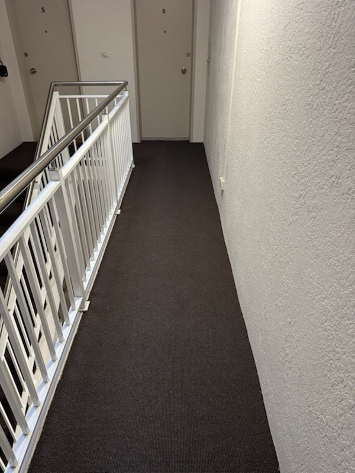 Charcoal carpet fitted neatly across a landing
