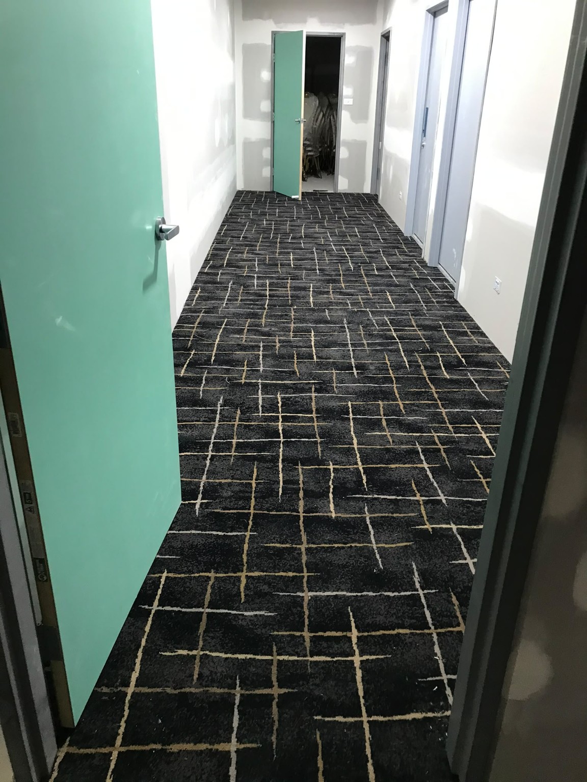 Patterned carpet tiles installed in a commercial corridor