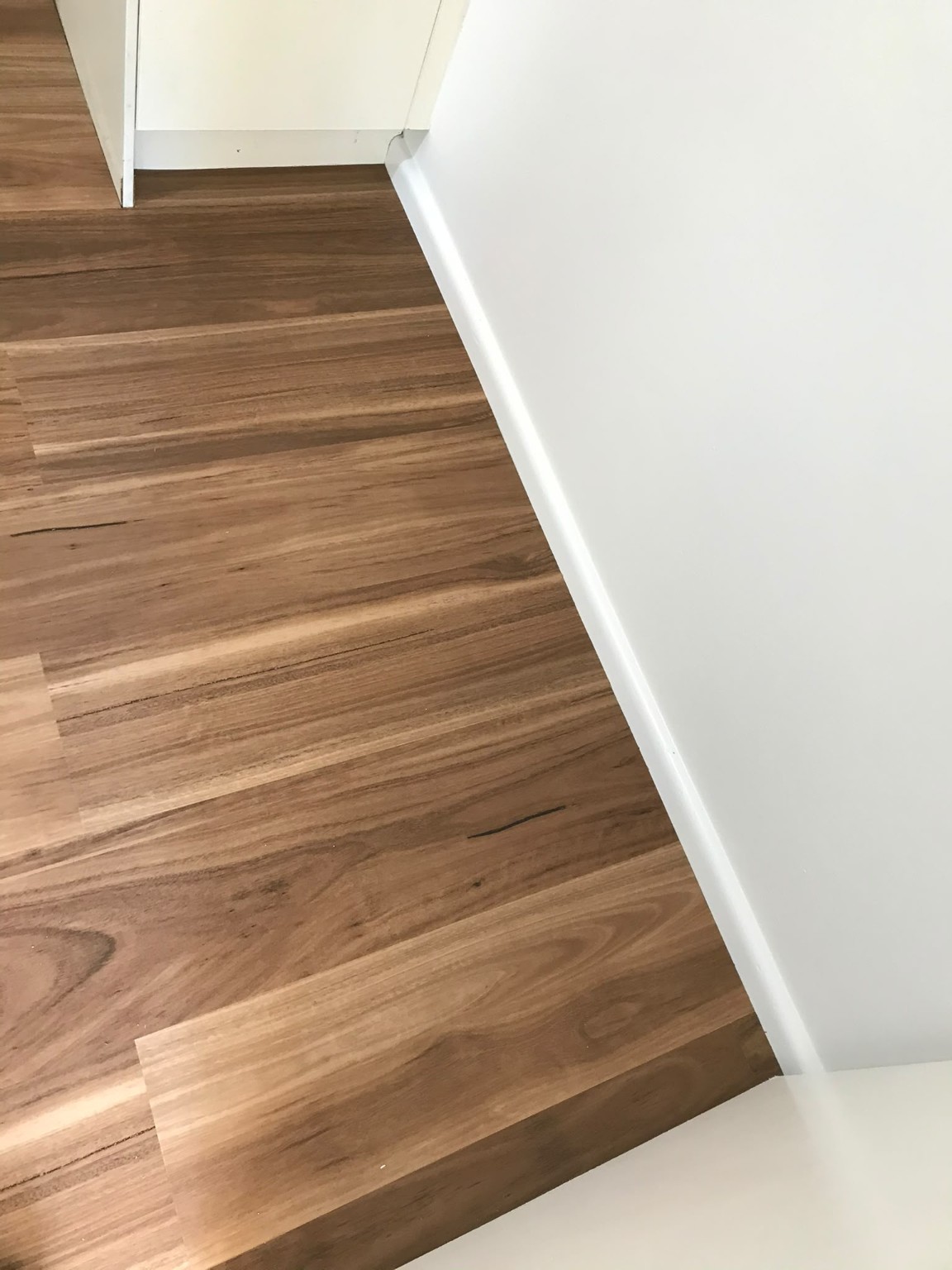 Timber-look vinyl plank flooring with clean wall junctions