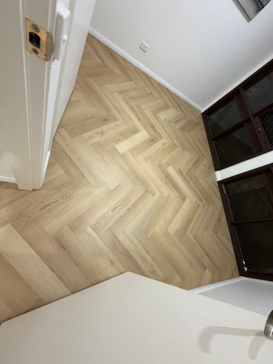 Completed herringbone timber floor with clean wall and doorway junctions